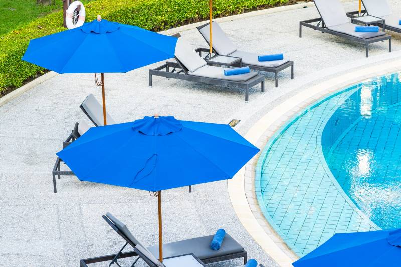 umbrellachairaroundoutdoorswimmingpoolhotelresortminjpg 63bfcd206f8a8